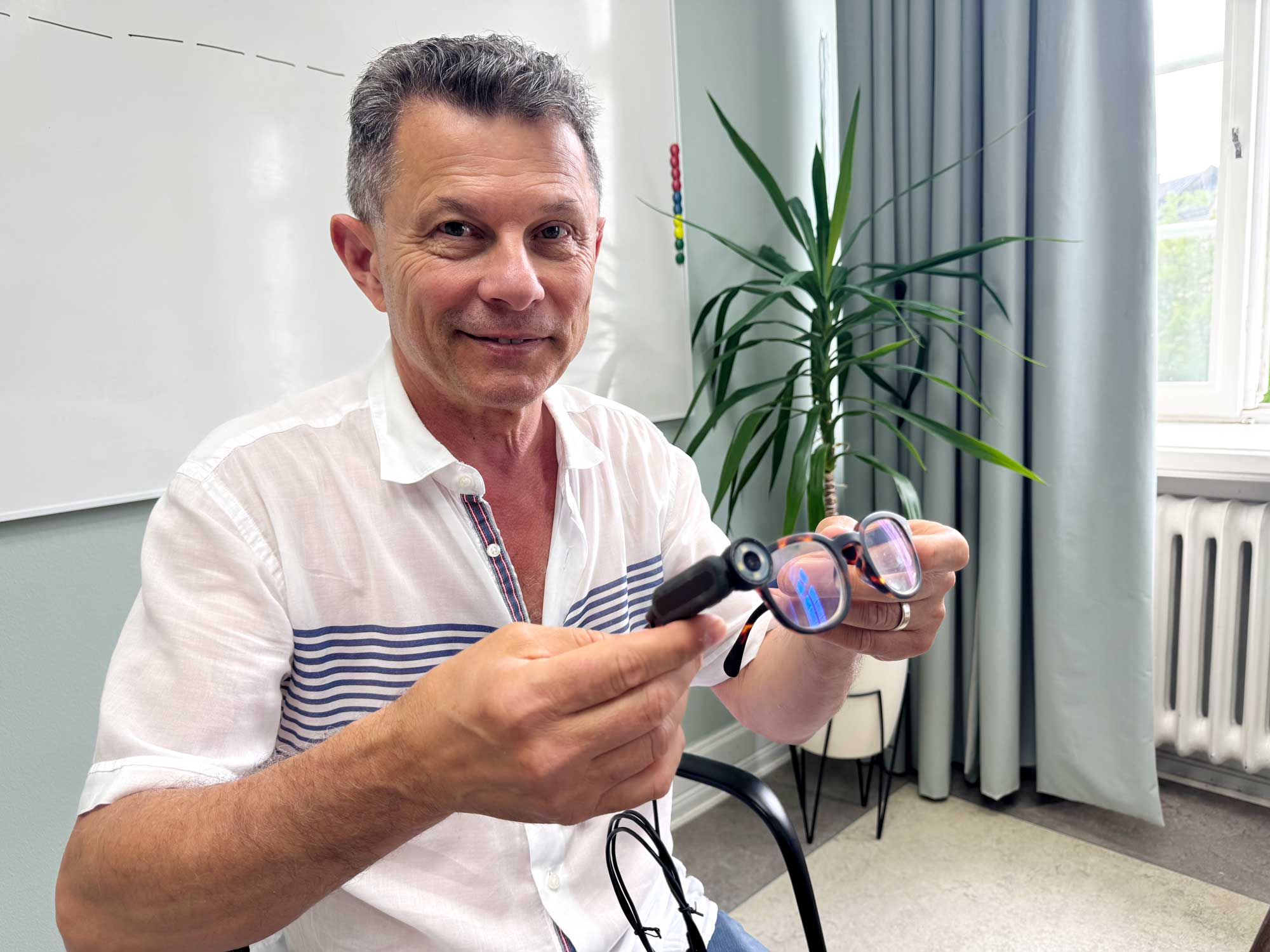 Max Tairi demonstrating a wearable camera attached to glasses.